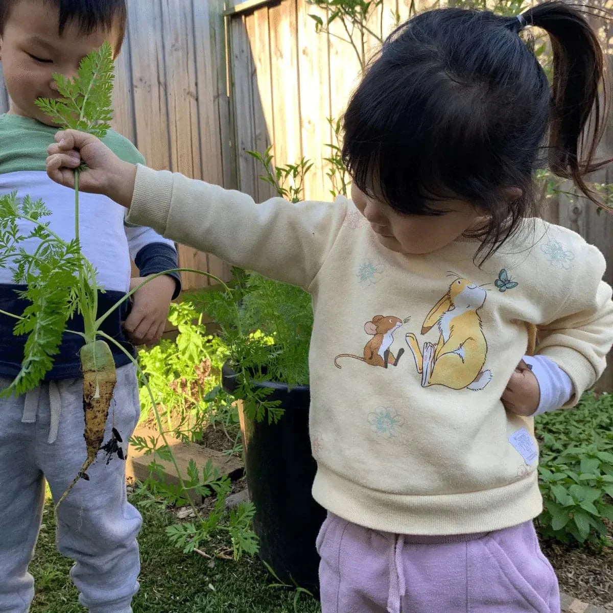 kid holding newly harvest crop